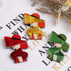 Detail of modern acrylic brooches featuring ladies with elegant wide-brimmed hats
