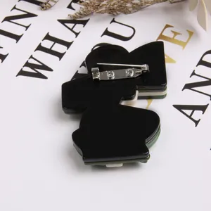 Detailed back view of acrylic modern lady brooch with silver safety pin closure