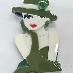 Fashionable acrylic brooch depicting an elegant girl wearing a green dress and hat
