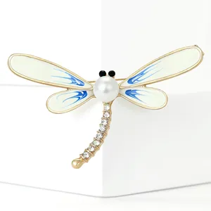 Elegant dragonfly brooch with pearl head, rhinestone tail and blue enamel wing details