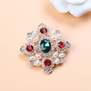 Detailed macro view of vintage Baroque brooch with red and green crystals and pearls