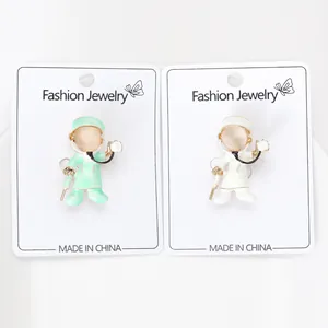 Detailed view of cute cartoon doctor and nurse brooches on display cards