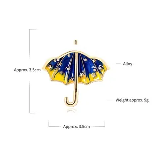 Creative starry sky umbrella brooch featuring blue enamel finish and gold-tone alloy