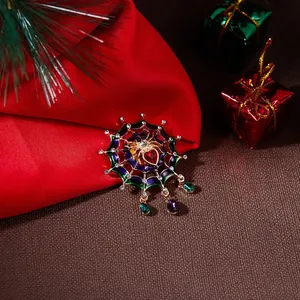 Detailed macro view of creative spider web brooch with rhinestones and colorful enamel inlay
