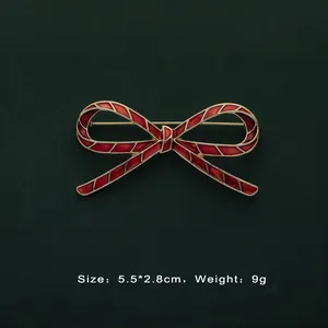 Detail view of Baroque red enamel bow brooch with 5.5cm size and 9g weight information