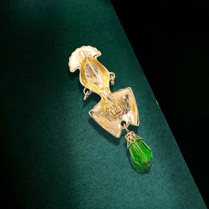 Vintage exotic African style gold brooch with a faceted green crystal drop pendant