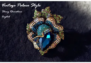 Close-up of a luxury vintage palace style flower brooch with blue crystal rhinestones.