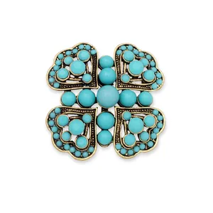 Vintage turquoise heart-shaped brooch with an antique gold finish detail and beads