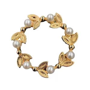 Elegant vintage Baroque gold leaf circular wreath brooch with white faux pearls.