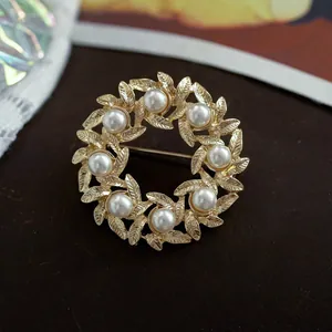 Elegant Baroque style wreath brooch featuring golden alloy leaves and white pearls