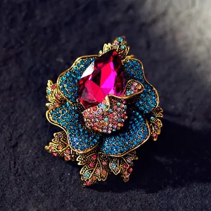 Luxury vintage crystal rose flower brooch with vibrant blue and fuchsia rhinestones