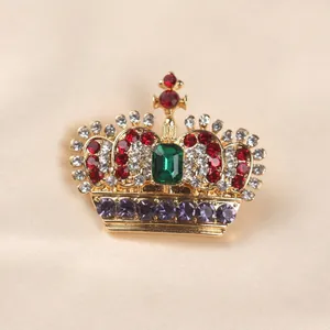 Exquisite close-up view of a regal crown brooch adorned with vibrant multi-colored crystals