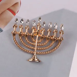 Vintage Hanukkah menorah brooch accessory with sparkling white crystals in gold plating