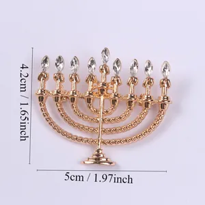 Detailed view of a gold Hanukkah menorah brooch with rhinestone accents and dimensions.