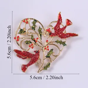 Detailed view of a vintage heart brooch with red birds and rhinestones, showing 5.6cm size.