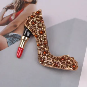 Detailed view of a vintage enamel high heel brooch with a lipstick heel and rhinestones.