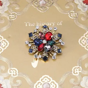 Detailopname van barokke vintage kruisbroche met gekleurde strass-steentjes