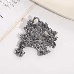 Detailed back view of a vintage gunmetal flower basket brooch with a secure pin closure