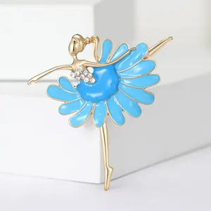 Close-up of ballerina brooch featuring vibrant blue enamel and clear rhinestones