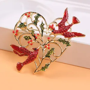 Vintage heart-shaped brooch with red birds, green holly leaves and rhinestones