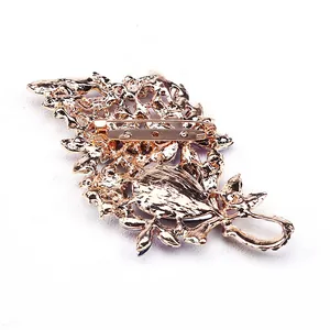 Back view of a large gold-finish crystal brooch with secure safety pin clasp