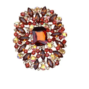 Vintage ornate brooch with amber crystal center and faceted glass stones for women