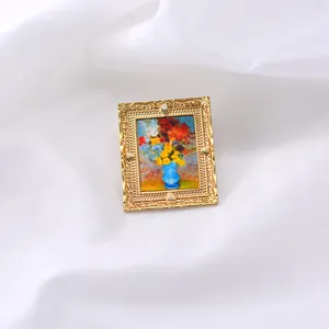 Dettaglio di una spilla barocca vintage con pittura a olio di fiori in un vaso blu.