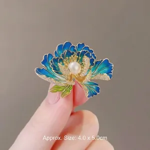 Elegant blue enamel peony flower brooch with a central pearl and crystals, size 4.0x5.0cm