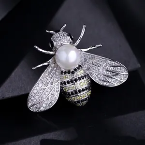 Elegant silver-tone bee brooch pin featuring pavé crystals and a lustrous white pearl