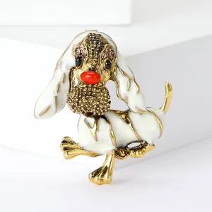Detailansicht einer eleganten weißen Emaille-Hundebrosche mit goldenen Akzenten