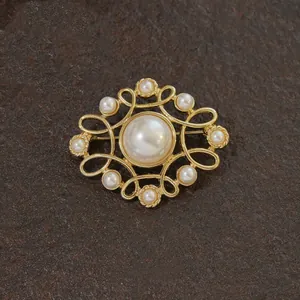 Macro detail of a vintage gold baroque cross brooch featuring lustrous white pearls