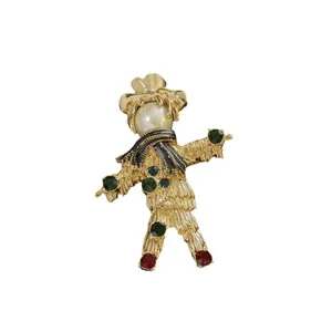 Elegant vintage golden baroque scarecrow brooch with pearl head and colorful gemstones