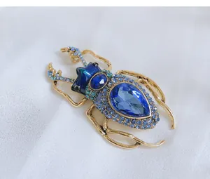 Detailed view of a vintage beetle brooch featuring blue rhinestones and large crystals