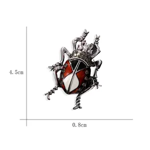 Detailed view of a vintage beetle brooch with dimensions 4.5cm by 0.8cm on white.