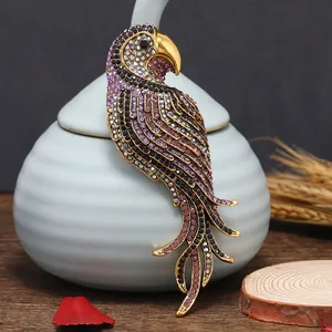 Close-up of vintage parrot brooch featuring colorful rhinestones and gold-toned alloy
