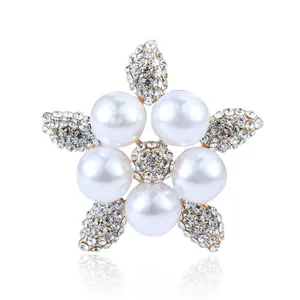 Close-up of elegant flower brooch with white pearls and sparkling rhinestones