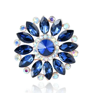 Detailed close-up of an elegant sunburst brooch featuring navy blue and iridescent crystals