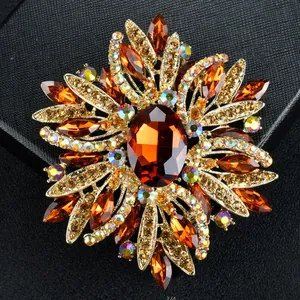 Detailed macro shot of a luxury amber crystal floral brooch on a black background
