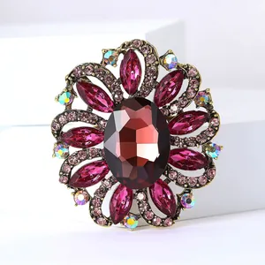 Detailed view of luxury vintage flower brooch with vibrant red crystals and rhinestones