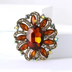 Detailed macro shot of a vintage amber crystal flower brooch with rhinestone accents