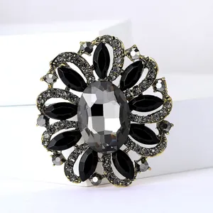 Detailed close-up of a vintage floral brooch with grey and black faceted rhinestones