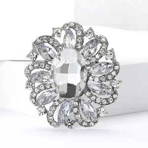Detailed view of luxury vintage flower brooch with clear rhinestones and oval crystal
