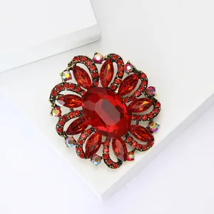 Detailed macro view of vintage red crystal flower brooch with rhinestone accents