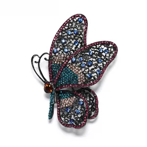 Detailed view of a vintage butterfly brooch with colorful rhinestones and hollow patterns.