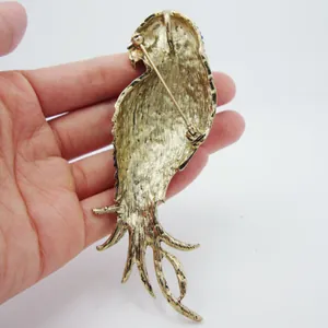 Vintage parrot brooch with colorful enamel details on gold-tone alloy backing