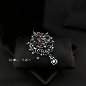 Vintage crown brooch with red and blue rhinestones for elegant suit accessories