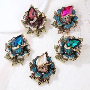 Set of luxury rose brooches encrusted with colorful crystals and teardrop stones