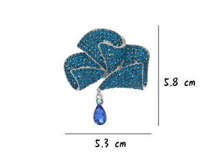 Detailed view of a blue floral rhinestone brooch with a teardrop pendant and size