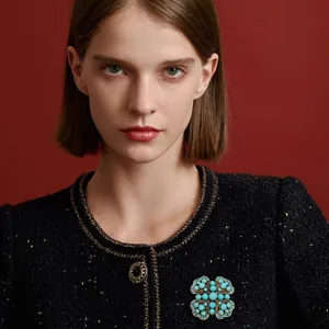 Vintage Bohemian enamel cross brooch on elegant black tweed blazer for women