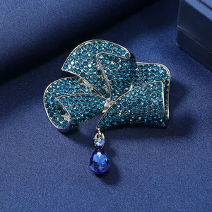 Elegant vintage style blue rhinestone bowknot flower brooch with a teardrop crystal pendant